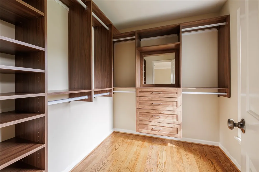 A second walk-in closet with tons of built-ins, shelving, and hanging space