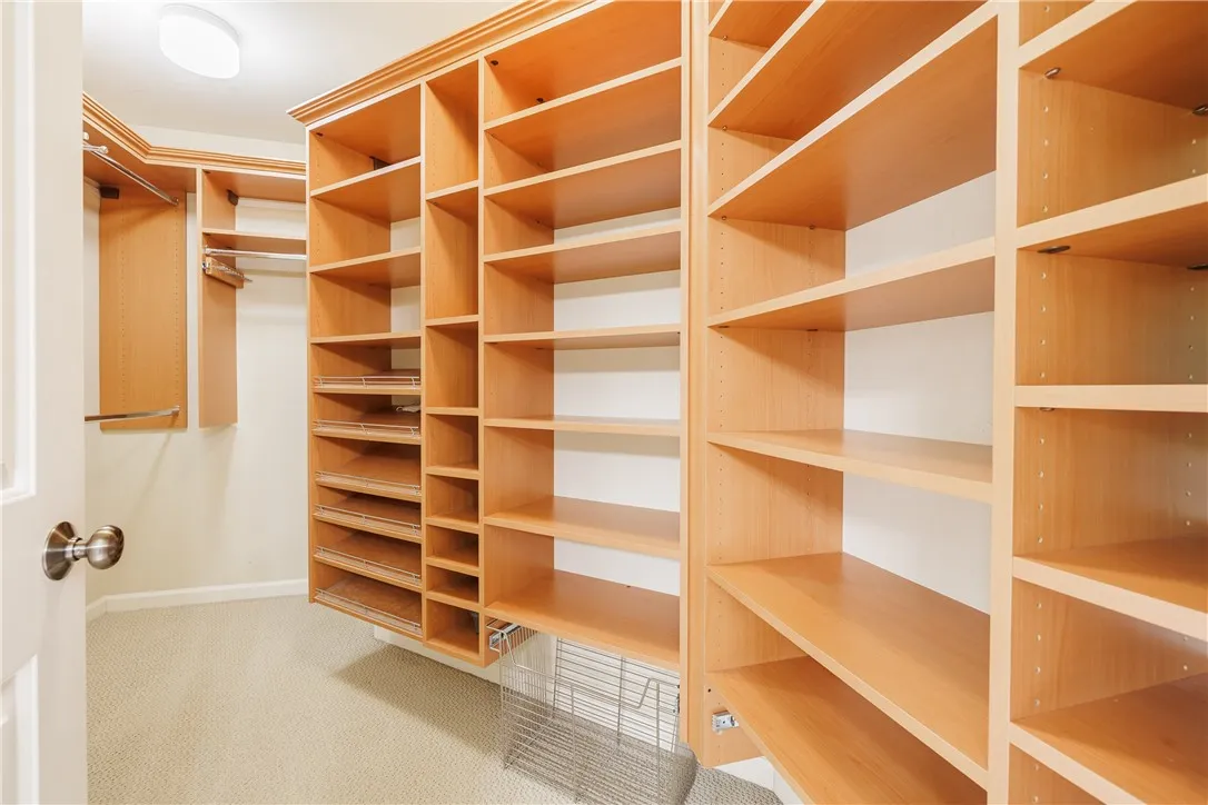 A second walk-in closet with tons of built-ins, shelving, and hanging space
