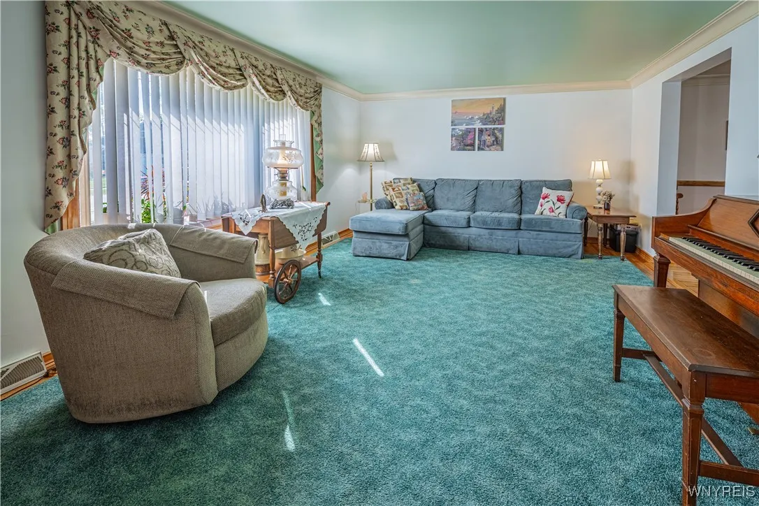 Spacious living room with hardwoods floors under the area rug.