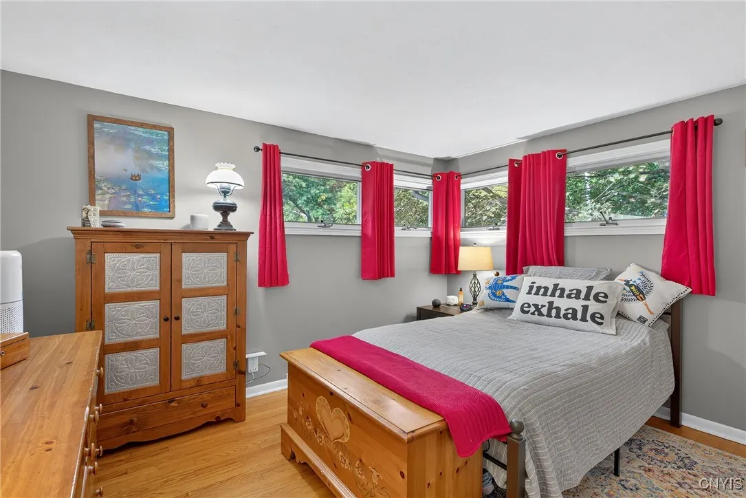 The primary bedroom sits at the front corner of the home with awesome privacy windows placed high enough that you have more options for furniture placement below.