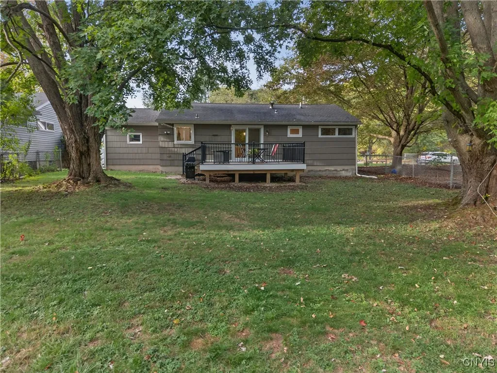 Mature trees provide shade close to the deck and house but are far enough away that their limbs don't hang over the roofline.