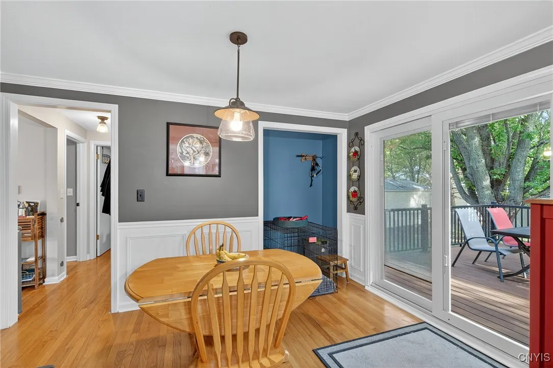 You could use the corner nook for a coffee bar or cocktail area... and just look how the slider door here creates a stunning backdrop while dining! Now we'll head down the hall at left to the bedroom wing...