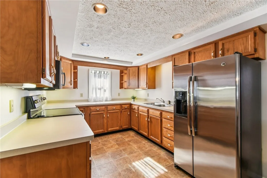 THE UPDATED KITCHEN HAS LOADS OF CABINETS AND LOTS OF COUNTER SPACE.