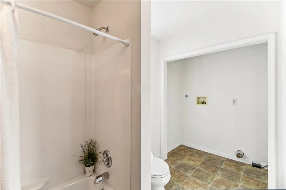 THE BATHROOM ALSO HAS THE CONVENIENCE OF BUILT-IN LAUNDRY AREA.