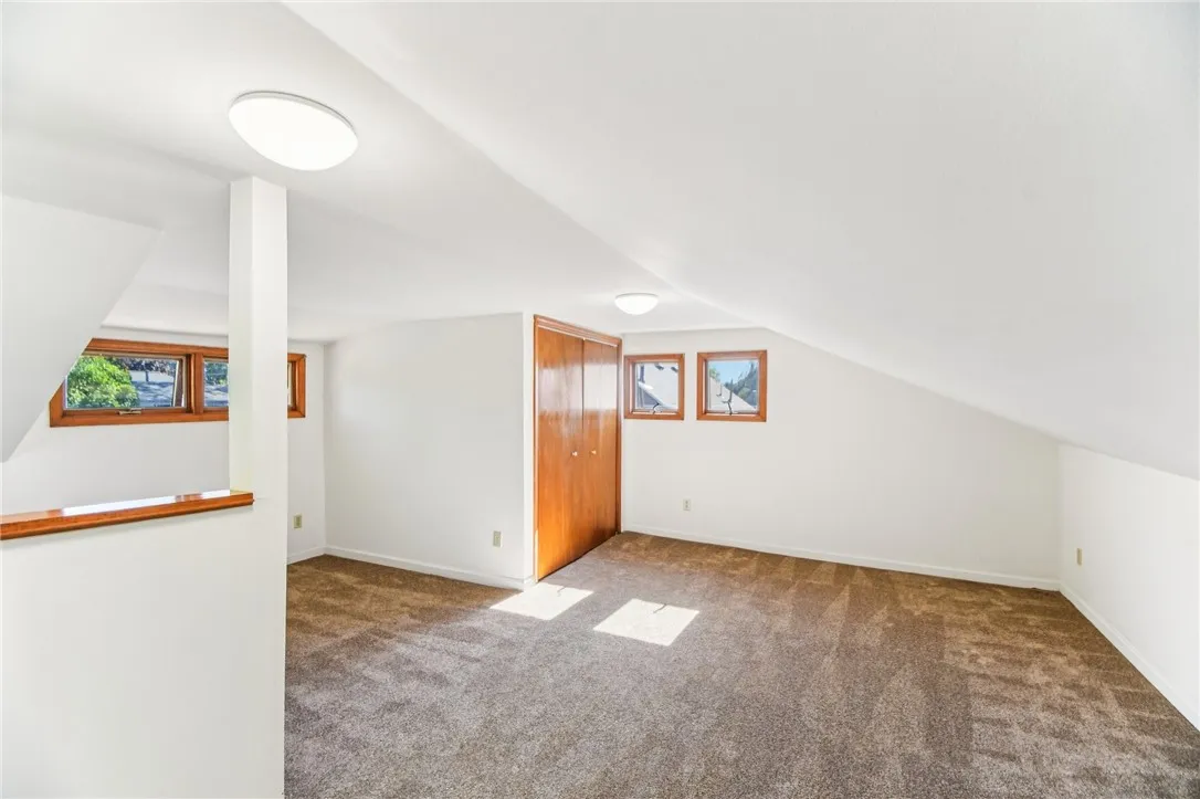 THE UPSTAIRS BEDROOM ENCOMPASSES THE WHOLE 2ND FLOOR. IT FEATURES WALL-TO-WALL CARPETING AND PLENTY OF WINDOWS.