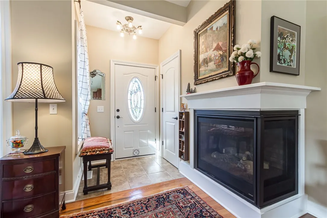 Welcoming front entry and guest closet with sharp corner gas fireplace!