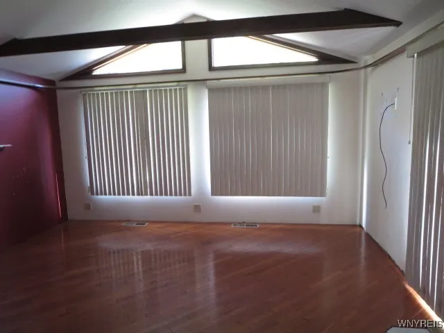 A full window wall overlooking the backyard & beam ceiling adds a special feature....
