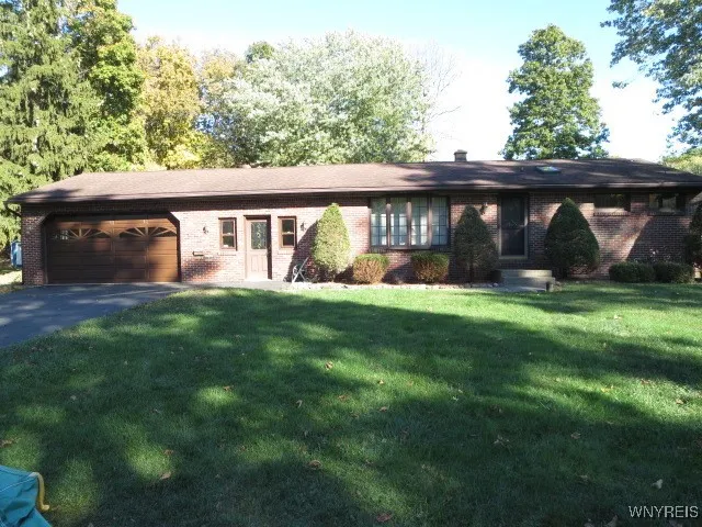 Wow! A 3 car garage with water, heat, work bench &  many extras for the person who woulld like space to tinker!