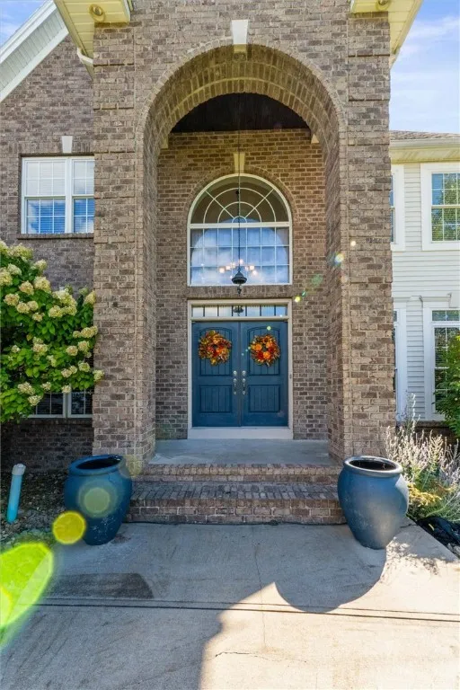 Make an entrance! This stunning brick archway and double-door design create the perfect first impression — timeless, elegant, and full of curb appeal.