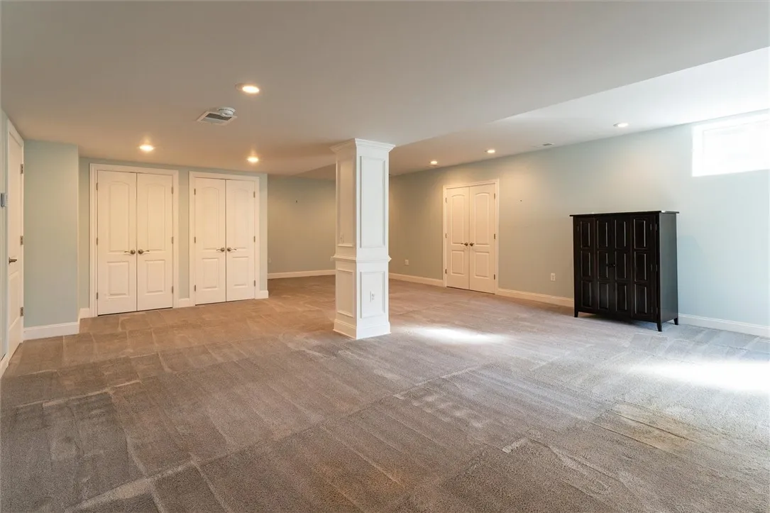This beautifully finished lower-level apartment offers incredible flexibility — perfect as a recreation space, in-law suite, or private teen retreat. Thoughtfully designed with the same high-end finishes as the main home, it features a full kitchen with stainless steel appliances, gas cooktop, and ample cabinetry. The open layout allows for both living and dining areas, while natural light and walkout access make this space feel bright and inviting.