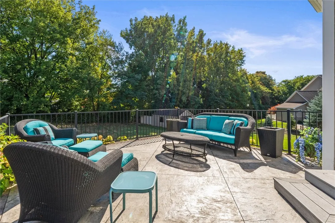 The stamped concrete patio offers a serene outdoor retreat, perfectly positioned to take in the peaceful wooded backdrop and lush greenery. Whether you’re enjoying your morning coffee or hosting sunset gatherings, the elevated setting and open vistas create a private and picturesque escape right at home.