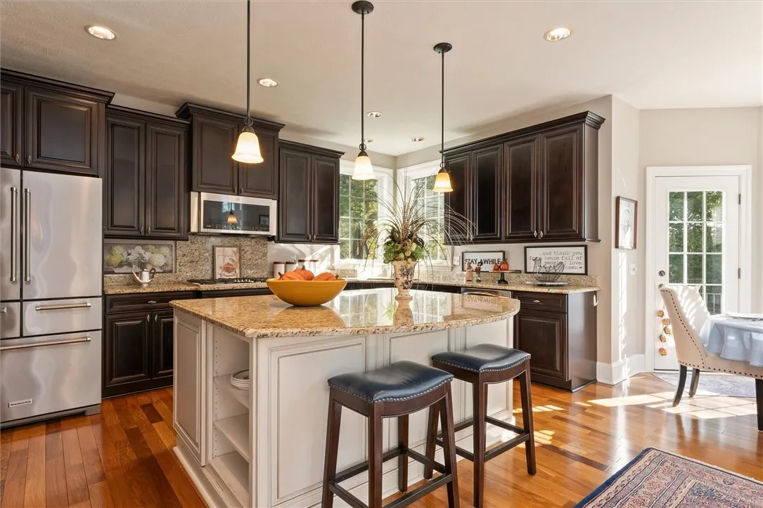 This expansive chef’s kitchen is designed for both cooking and entertaining — featuring rich wood cabinetry, granite countertops, stainless steel appliances, and a spacious island that invites everyone to gather. Thoughtful design meets timeless craftsmanship in this heart-of-the-home.”