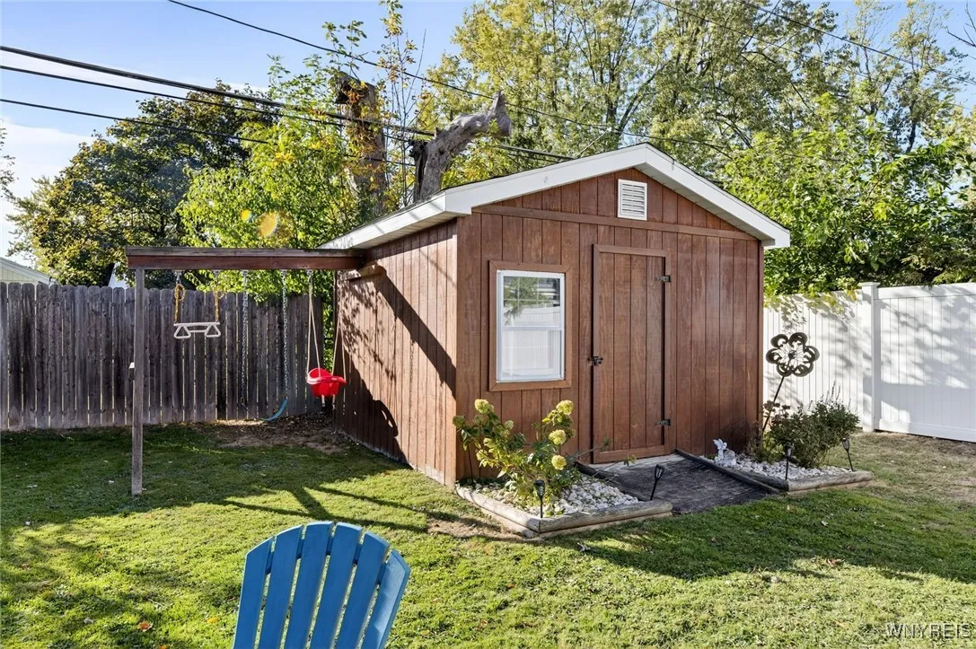 Generous shed for mower and gardening tools.
