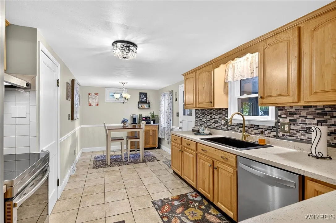 Large eat-in kitchen...all the appliances will stay. Door to screened in porch and basement/garage.
