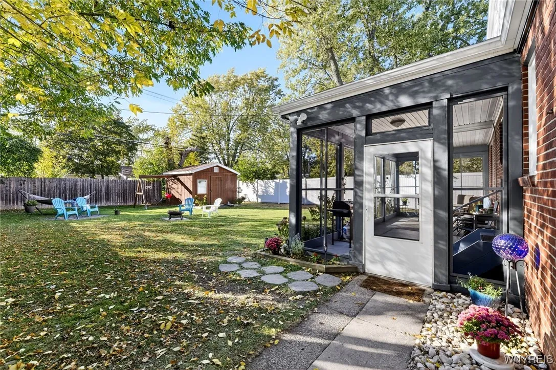 Privacy fence surrounds the yard - entrance to screened in porch with access to the kitchen as well. Say goodbye to bees when your enjoying your summertime meals.