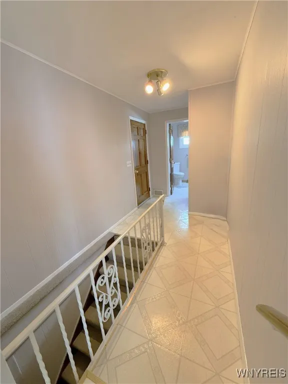 Hallway leads from the kitchen to the half bath, garage and basement.