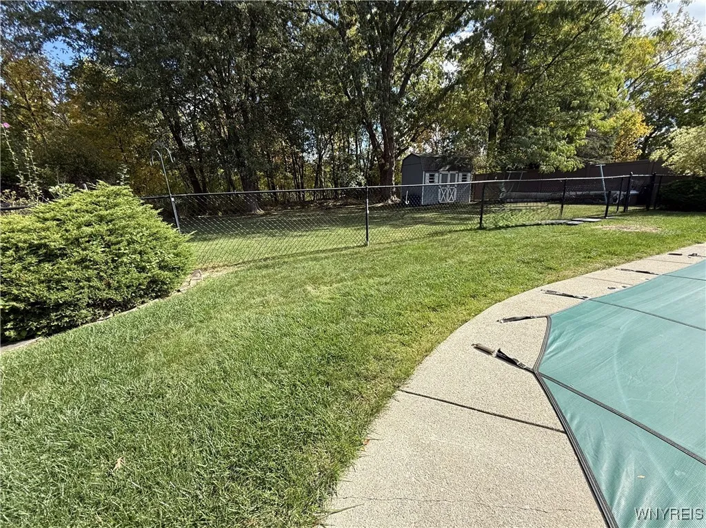 In addition to the fenced yard, you have extra green space beyond plus a shed for extra outdoor storage.