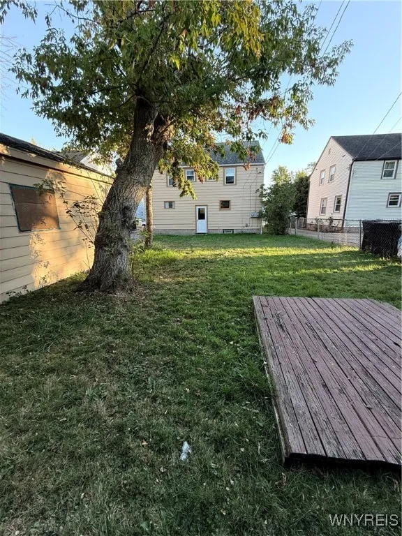 The backyard has a deep lot for your use.