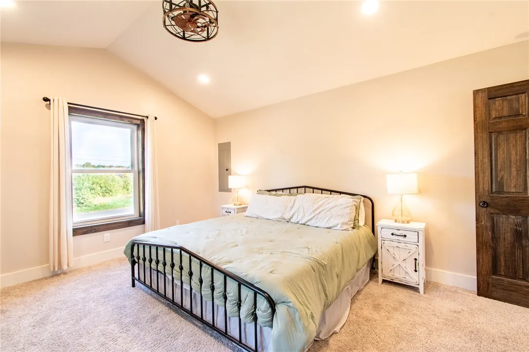 Primary bedroom with cathedral ceiling and walk in closet.  Each bedroom has a thermostat for heat and AC