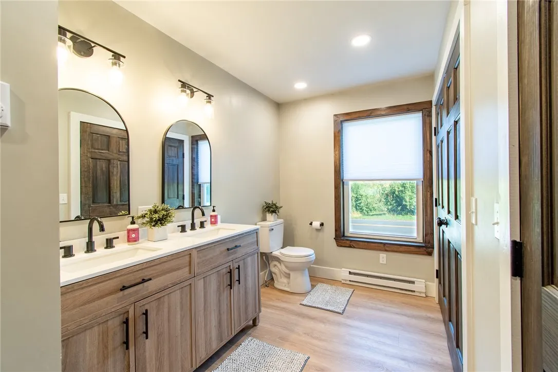 1st floor full bathroom with double vanity,  tub and laundry room.  Lots of storage too!