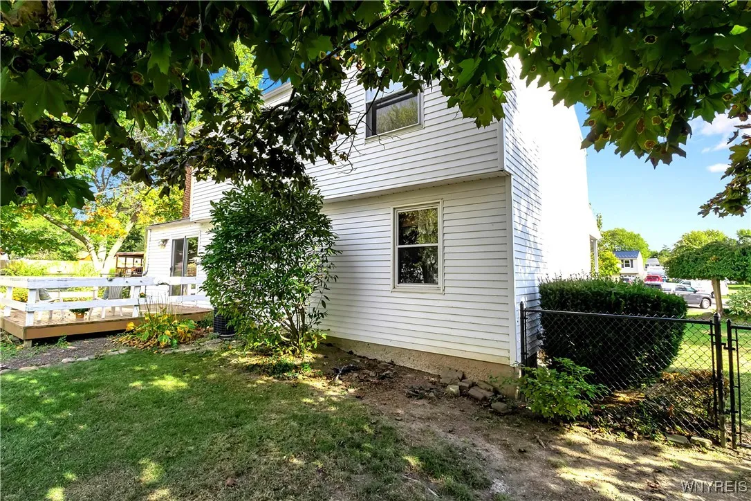 close up view of low maint vunyl siding + fenced yard with gates.
