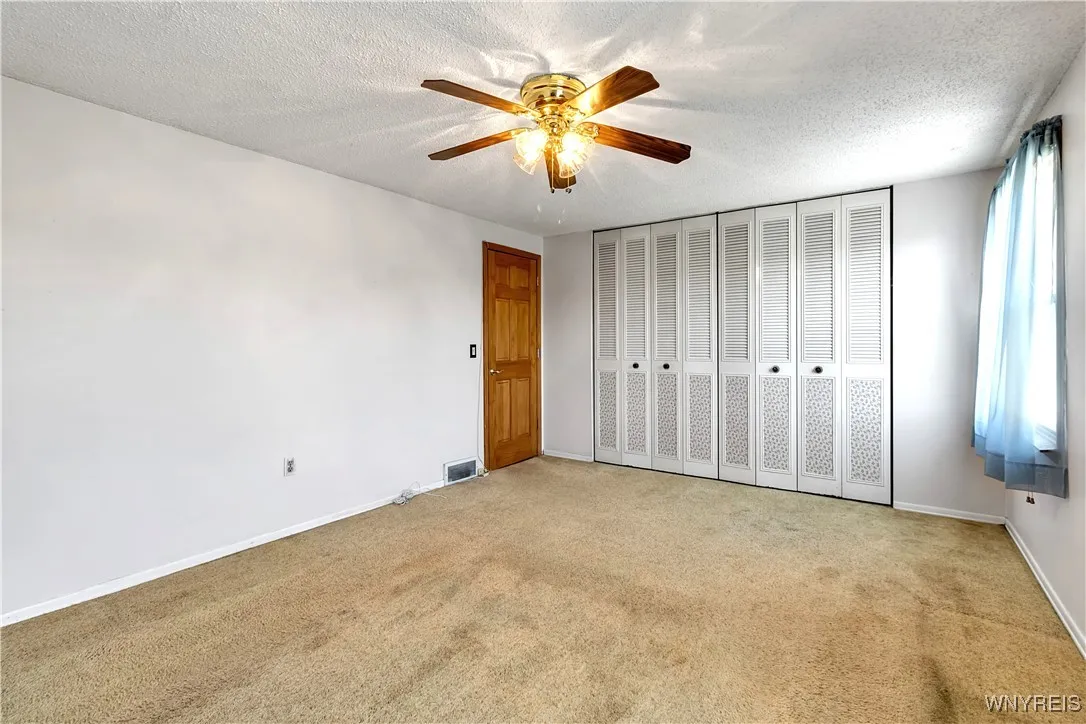 2nd floor Carpeted 16x 12 BDRM with double closets, ceiling fan, 2 double hung windows + 6 panel entry dr