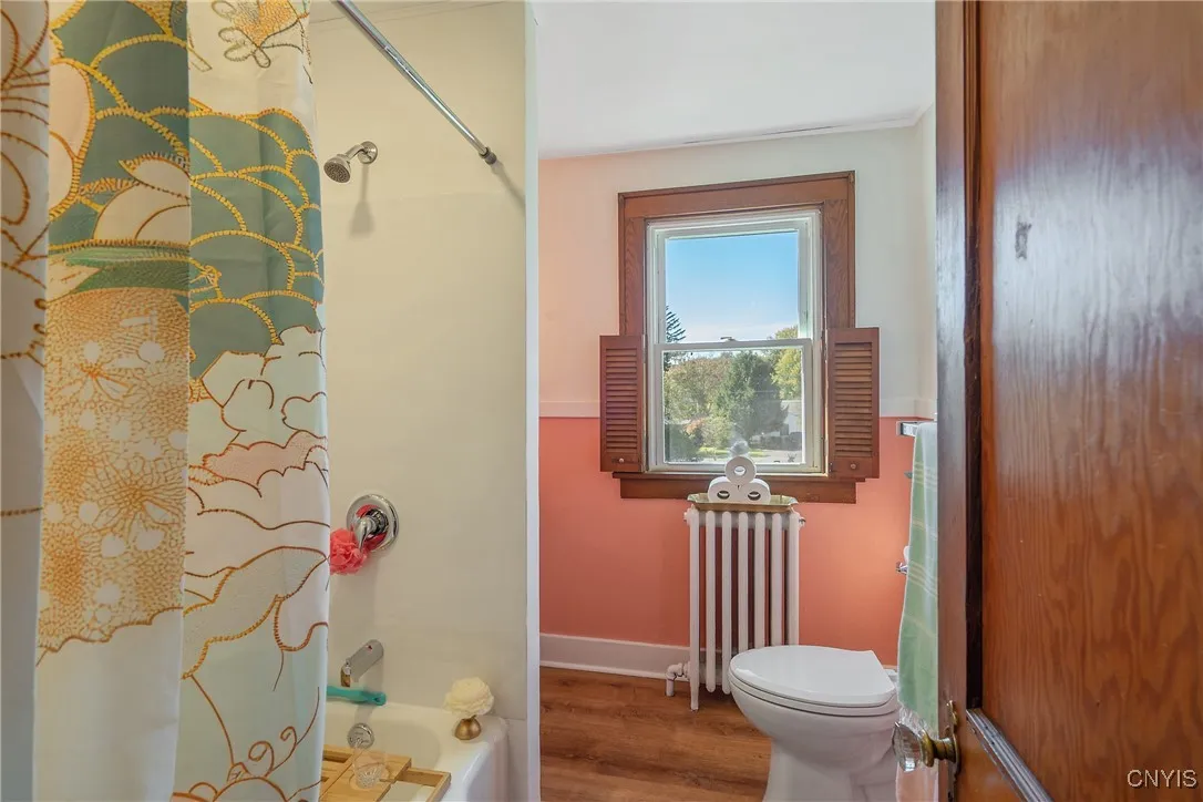 This bright and cheery room is also warm and cozy with the radiator and natural wood trim.