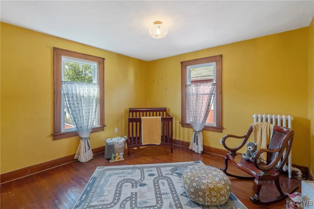 Bedroom #2 is large and continues the home's theme of natural wood floors and trim around the new windows.