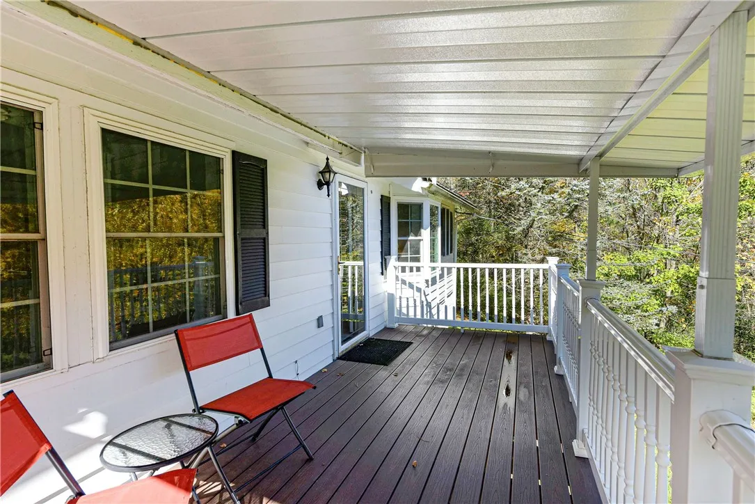 Deck with Awning looks over the pond and out towards the Bristol Hills