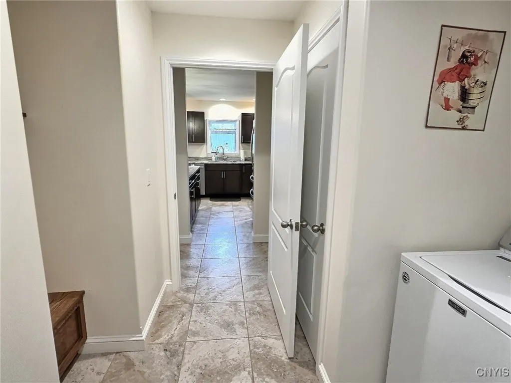 Entry way from garage with laundry,coat closet and seating area