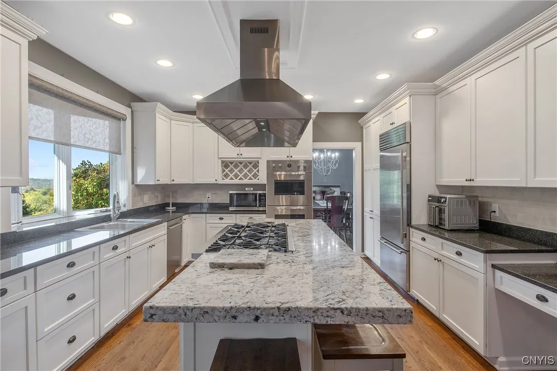 Large Kitchen with custom exhaust hood over an 8 burner stove!