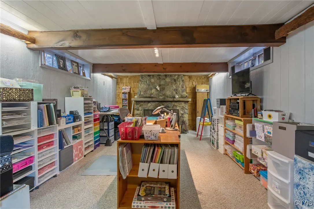 Lower level has a large, family room with beamed ceilings.
  Fireplace in rear.