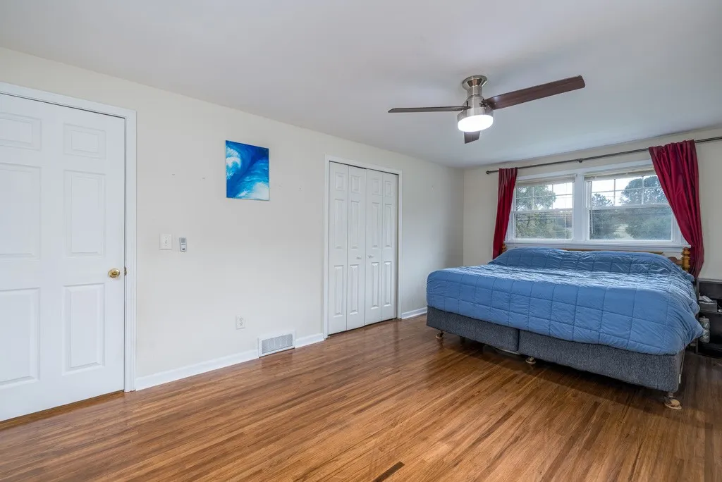 Primary bedroom with closet and a walk-in closet 
