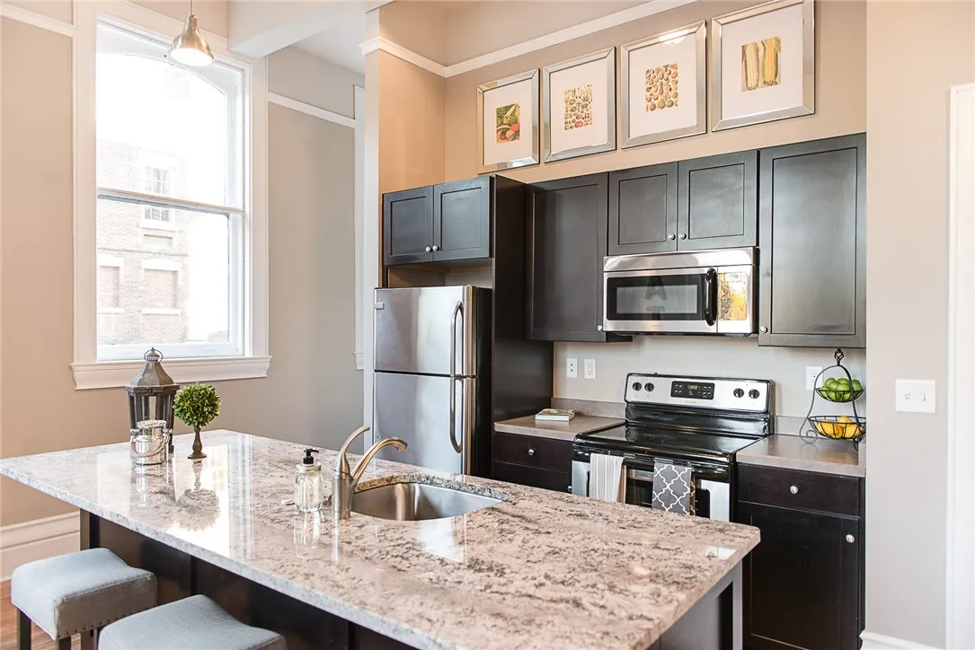 Typical modern kitchen with breakfast bar/island (with granite top), stainless steel appliances, dishwasher, etc.