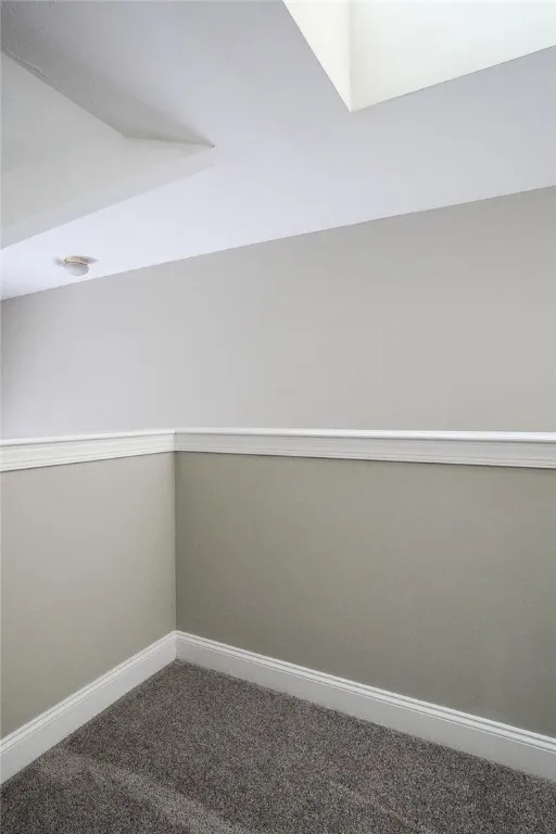 View of typical second floor loft with skylights, and bedroom, walk-in closet and full bathroom