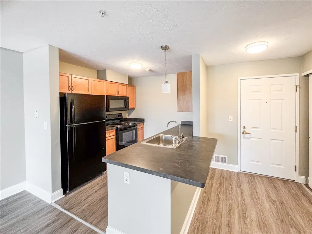 Typical well-equipped kitchen with breakfast bar and dishwasher