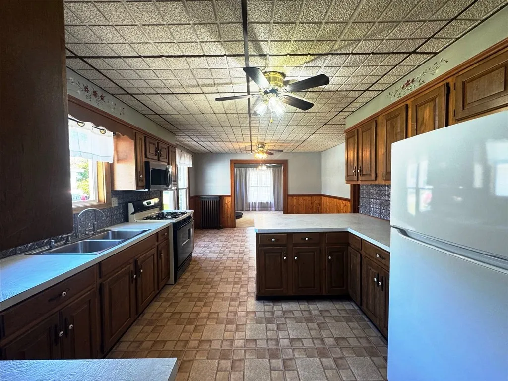 Eat-in kitchen with breakfast bar open to living room