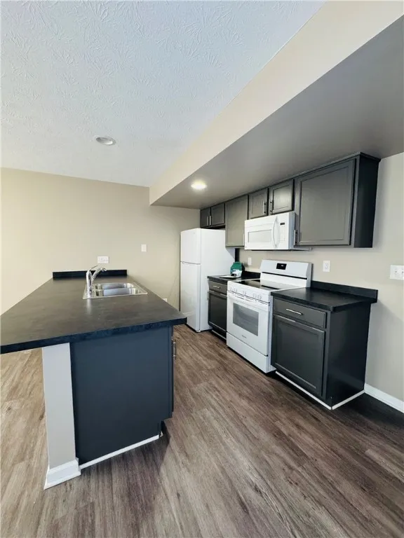 Typical kitchen with large breakfast bar (countertop & cupboard colors may vary)