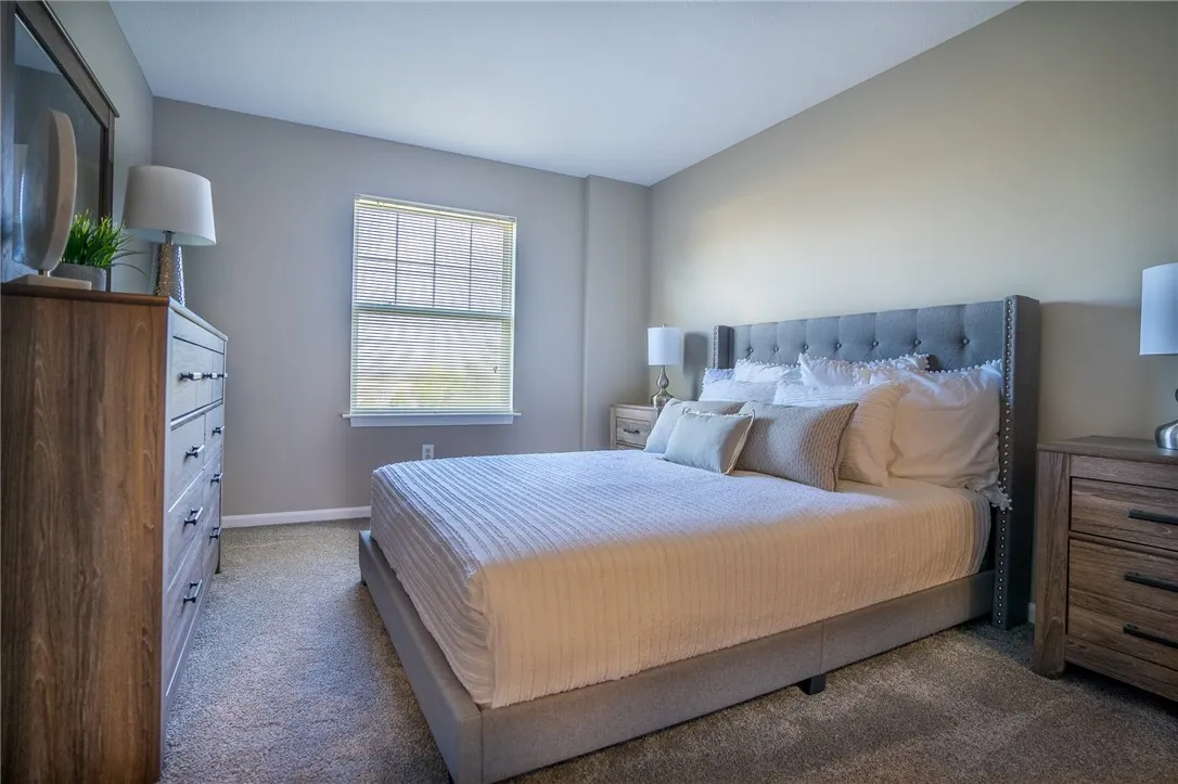 Typical master bedroom with wall to wall carpet and large walk-in closet