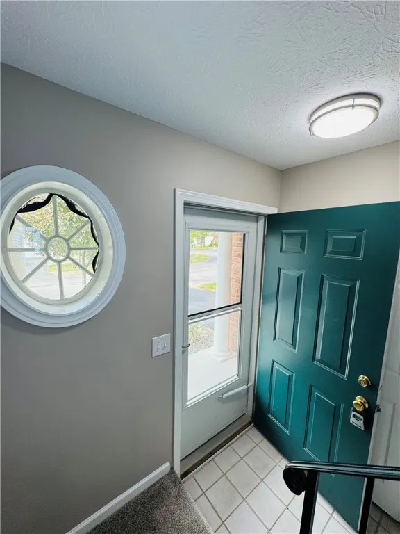 View of typical foyer with front door open from stairway to second floor