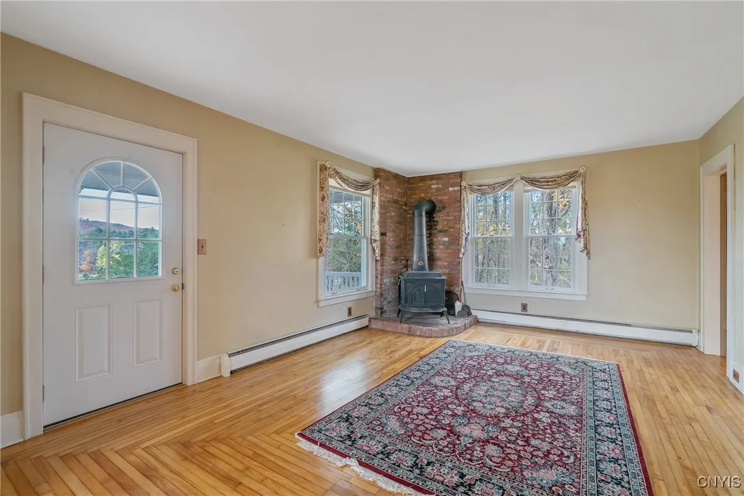 Enter into  the formal living room with beautiful hardwood floors.