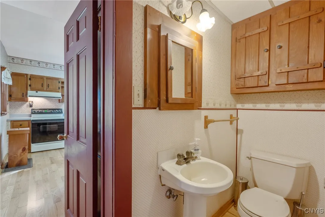 half bath downstairs located between bedroom and kitchen area