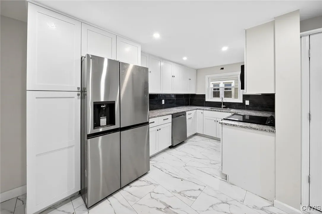 Beautifully remodeled kitchen featuring brand-new appliances, updated cabinetry, and modern finishes.granite countertops and all new cabinetry