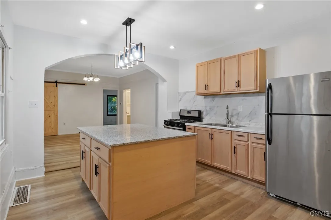 This kitchen is the heart of the home. Granite countertop on the kitchen island. Island has cabinets on both sides providing plenty of storage.