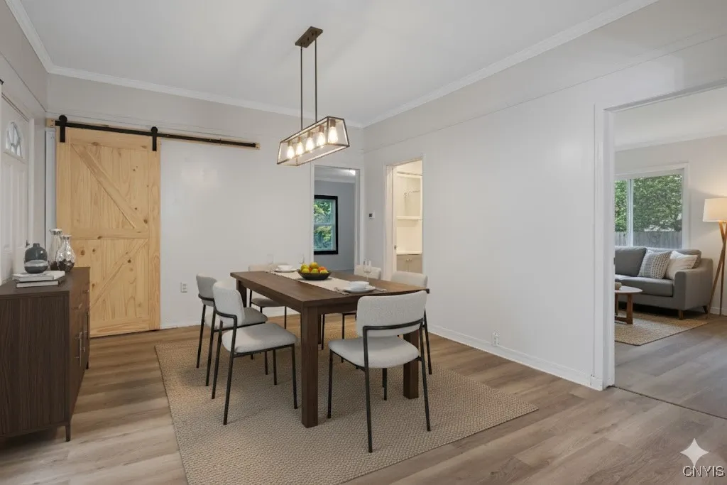 Large dining room. Potential laundry room just beyond the barn door with access to the backyard, basement, & attic crawl space.
