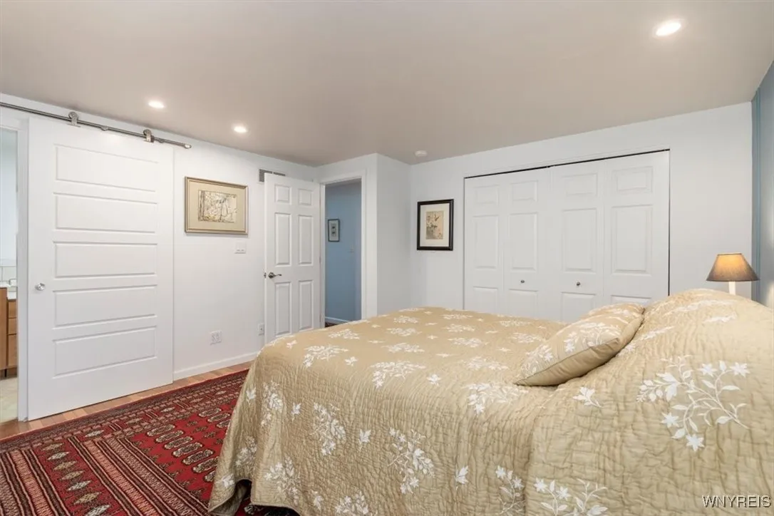 Lovely primary bedroom - double closets (with closet organizer systems), hardwood floor and en-suite bath
