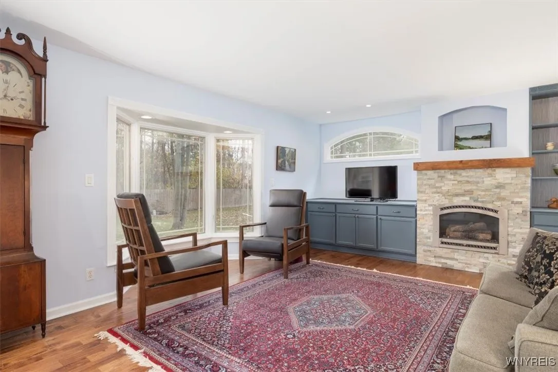Large family room with bay window, 3/4/" hand scraped oak hardwood flooring and stunning gas fireplace