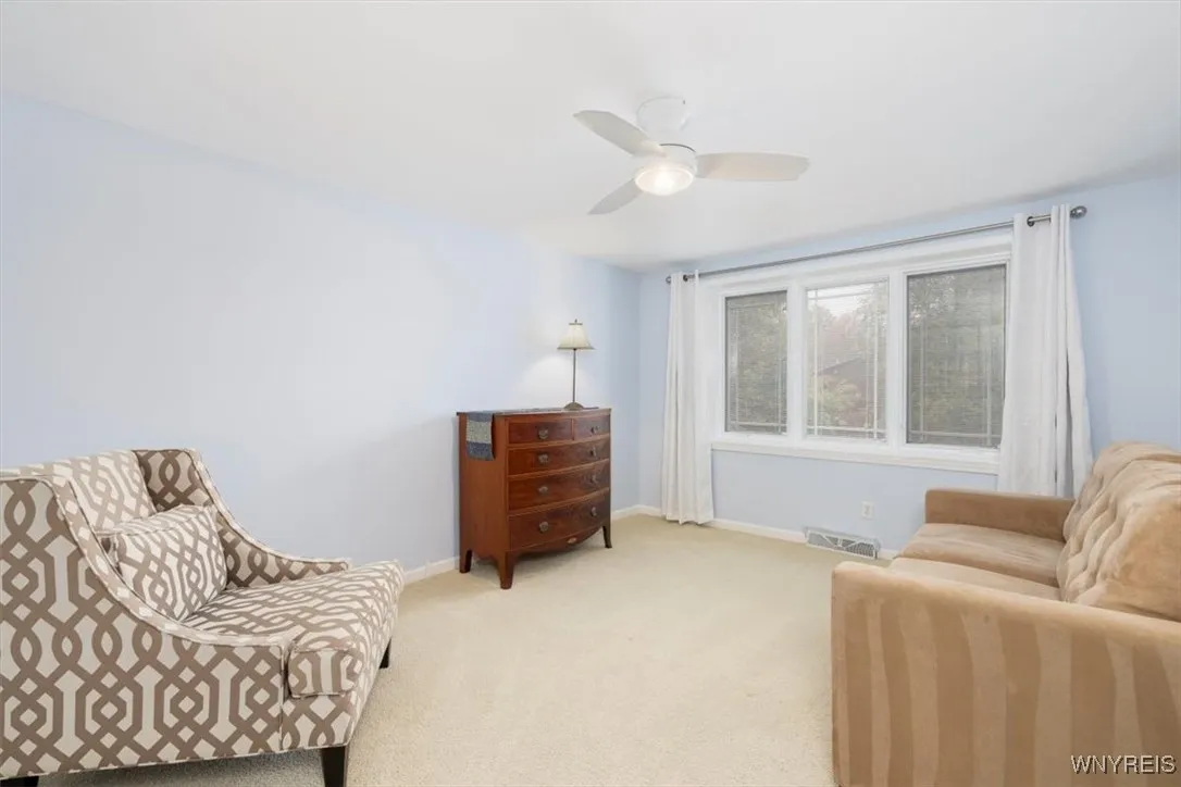 4th bedroom with ceiling fan and closet organizer