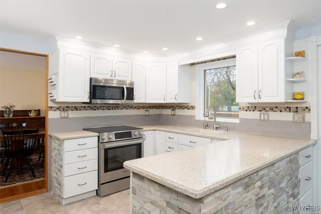 Gorgeous stone counter base, recessed lighting, new Bosch electric range (Dec 2024) - gas hookup still in place