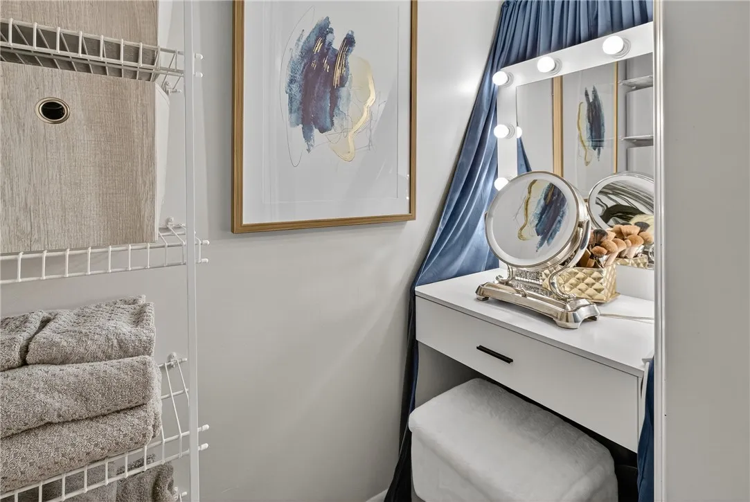 THIS LARGE CLOSET IS BEHIND THE BIFOLD DOOR IN THE BATHROOM